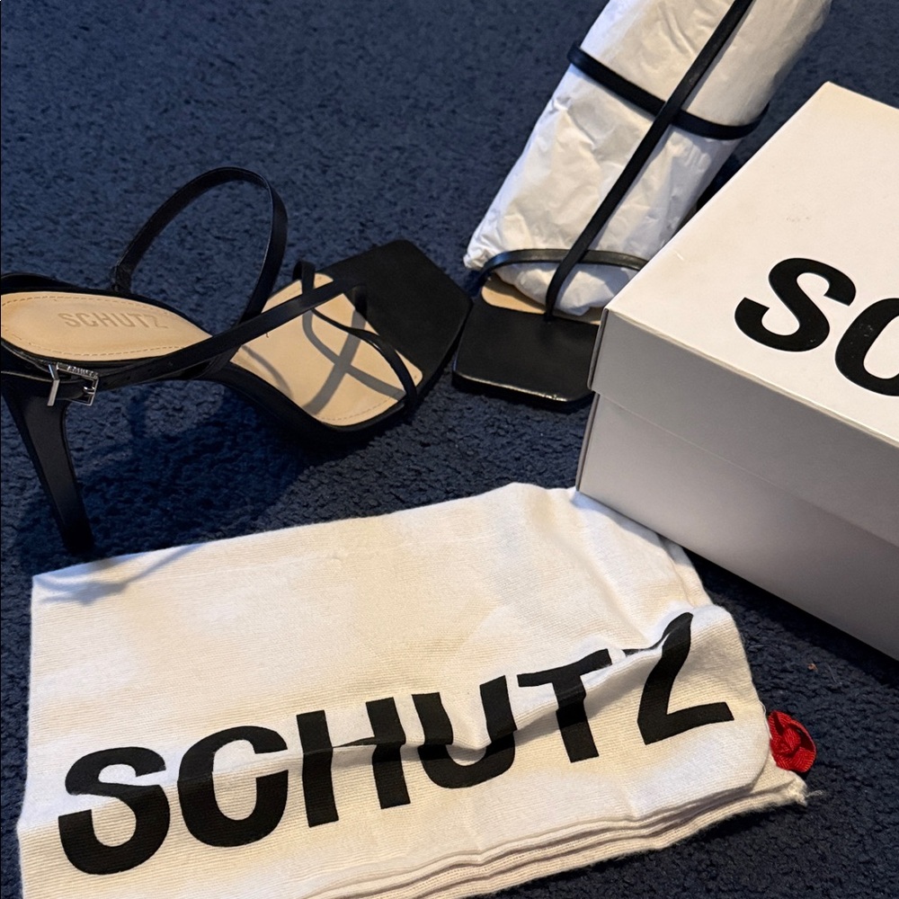 SCHUTZ Black and White Logo Design